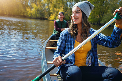 Buy stock photo Couple, canoe and lake rowing for nature holiday or exploring outdoor, environment or journey. Man, woman and happy or travel weekend on island river at camp for vacation in Colorado, calm or forest