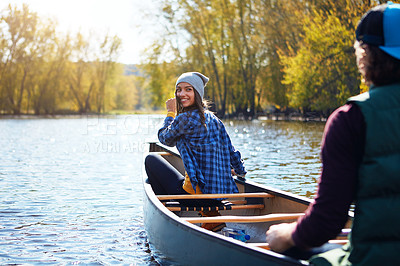 Buy stock photo Shot of a young couple going for a canoe ride on the lake