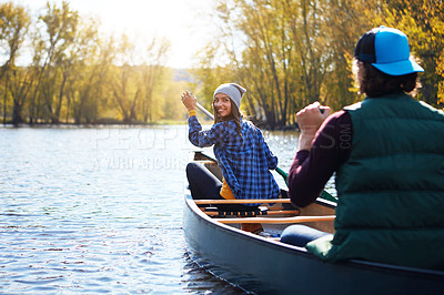 Buy stock photo Shot of a young couple going for a canoe ride on the lake