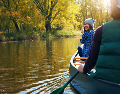 Buy stock photo Shot of a young couple going for a canoe ride on the lake