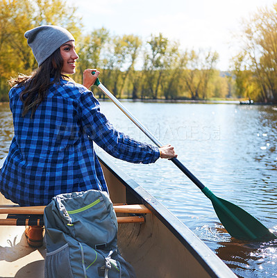 Buy stock photo Shot of a young woman going for a canoe ride on the lake