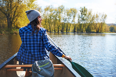 Buy stock photo Shot of a young woman going for a canoe ride on the lake