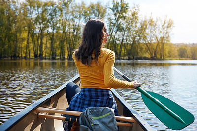 Buy stock photo Woman, back and canoeing in nature on river, wellness hobby and backpack for supplies with paddle for rowing. Vacation, relax and explore exercise on travel holiday, canoe boat and trees on lake