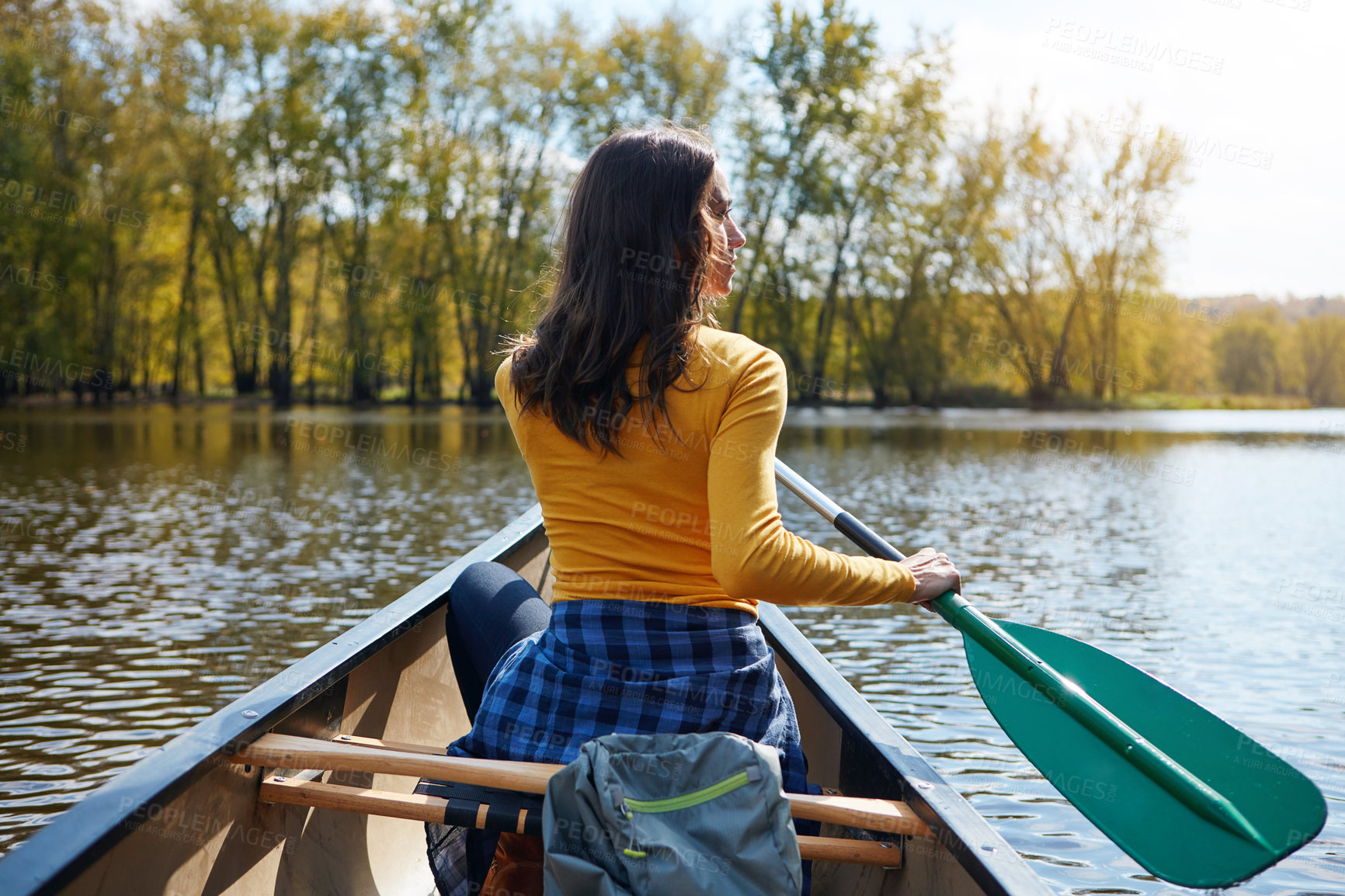 Buy stock photo Woman, back and canoeing in nature on river, wellness hobby and backpack for supplies with paddle for rowing. Vacation, relax and explore exercise on travel holiday, canoe boat and trees on lake