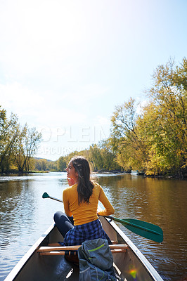 Buy stock photo Shot of a young woman going for a canoe ride on the lake