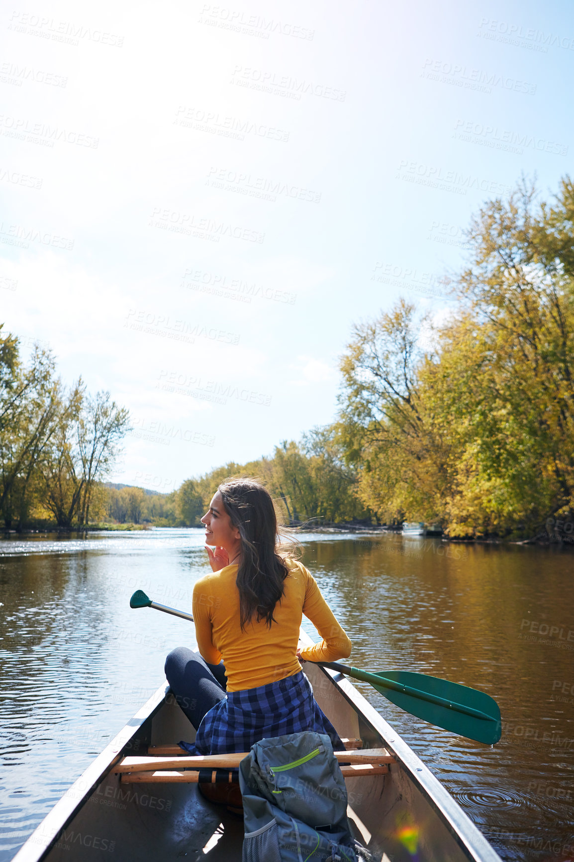 Buy stock photo Shot of a young woman going for a canoe ride on the lake