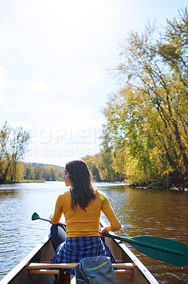 Buy stock photo Shot of a young woman going for a canoe ride on the lake