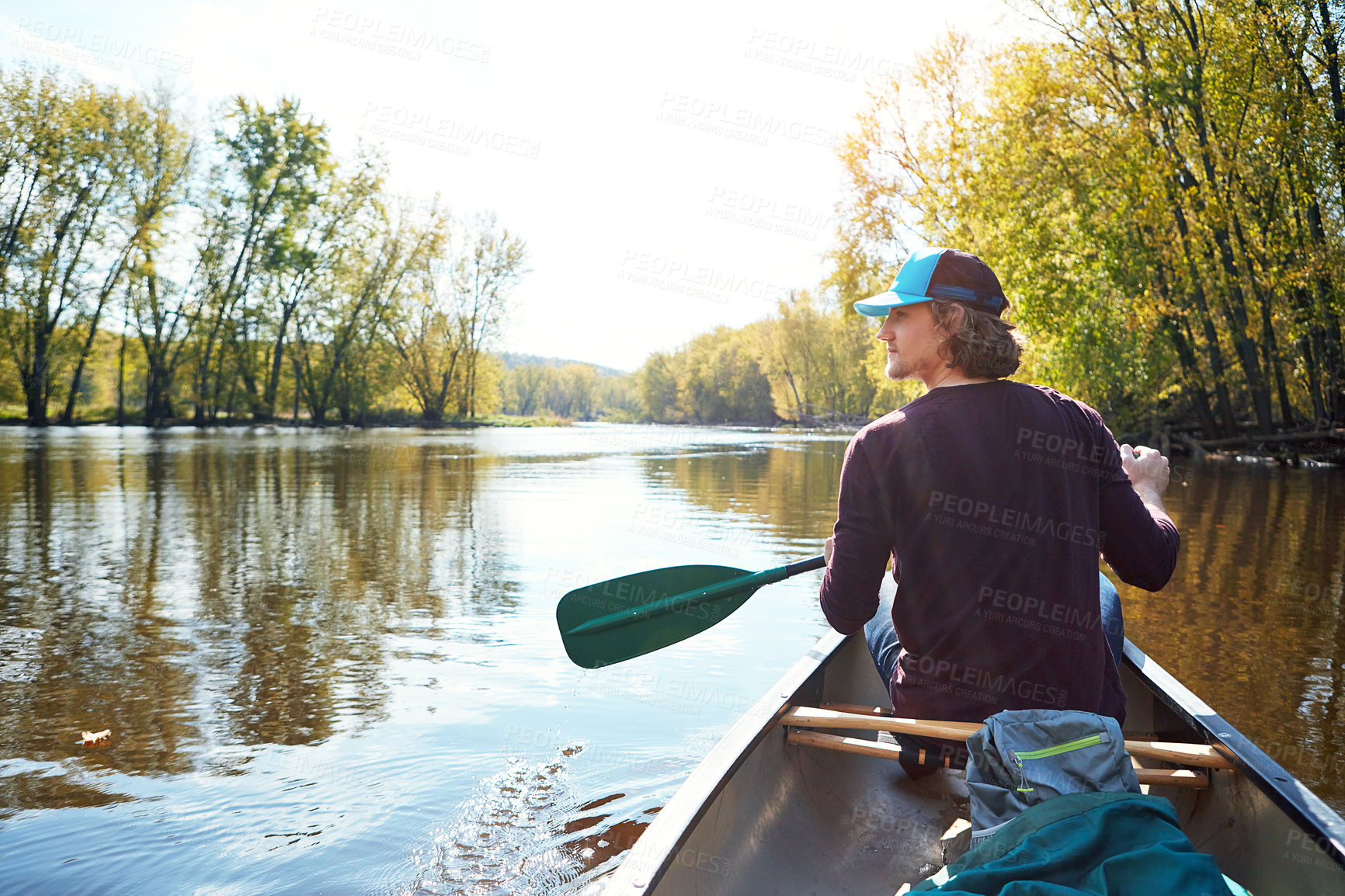 Buy stock photo Man, canoeing and lake rowing in nature for morning adventure or exercise, exploring or island. Male person, back and Colorado traveling for outdoor hobby with boat at camp site, forest or nature