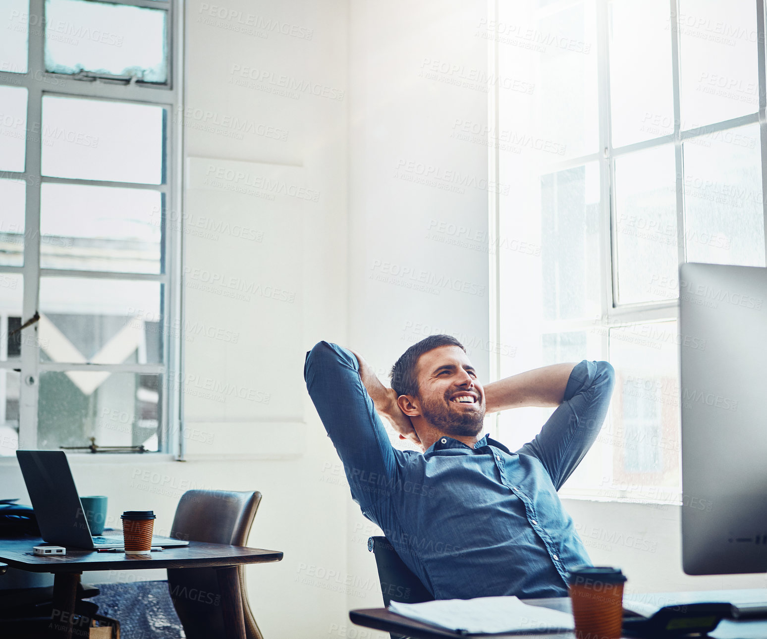 Buy stock photo Business, relax and happy man at desk for stretching, productivity or done with project in office. Smile, computer and employee with arms behind head for satisfied, achievement or deadline complete
