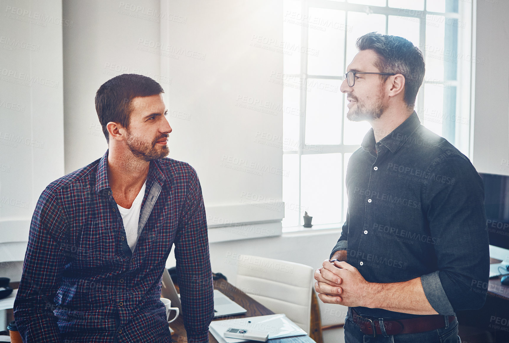 Buy stock photo Shot of colleagues talking in the office