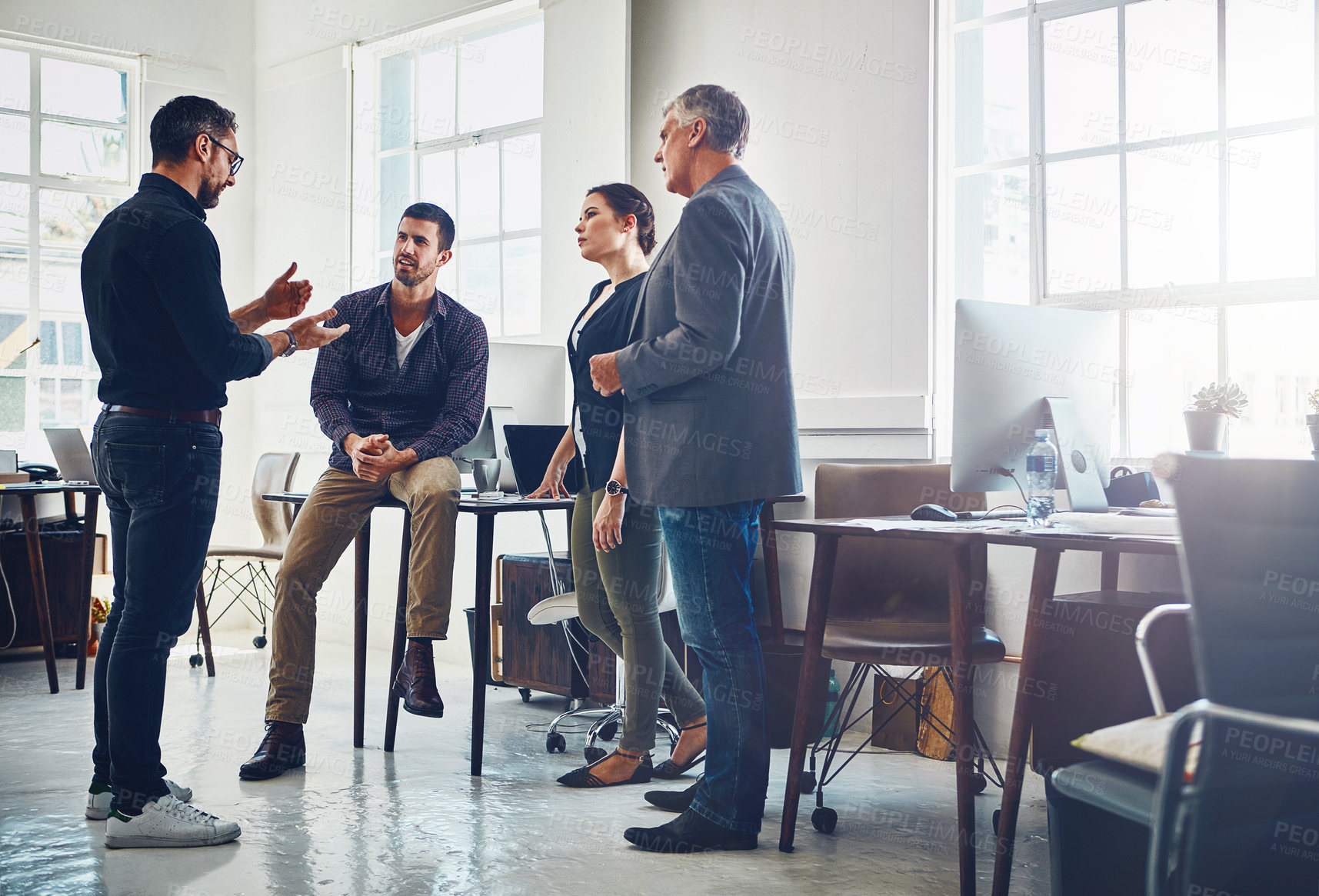 Buy stock photo Shot of a group of designers having a discussion at work