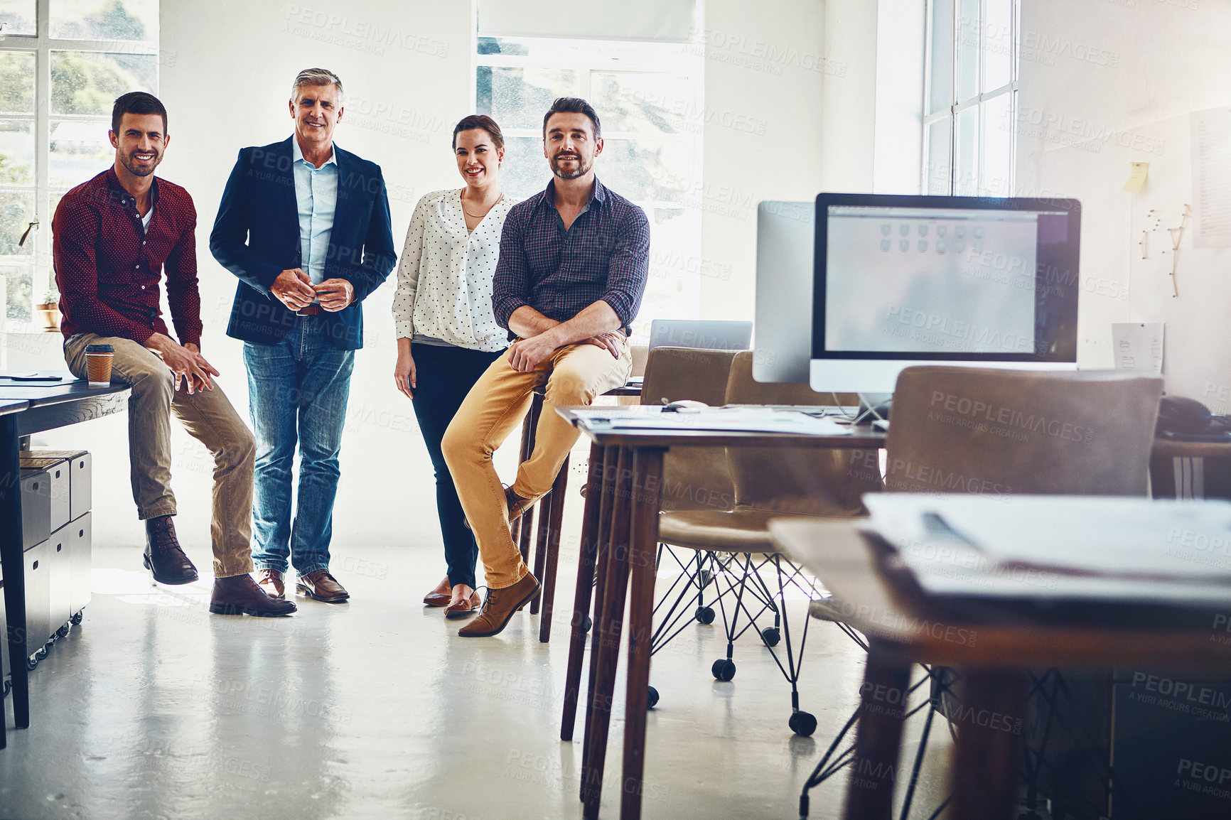 Buy stock photo Portrait of a team of creative workers standing together in an office