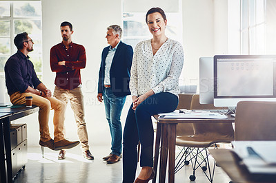 Buy stock photo Portrait of a young woman posing while her colleagues stand in the background