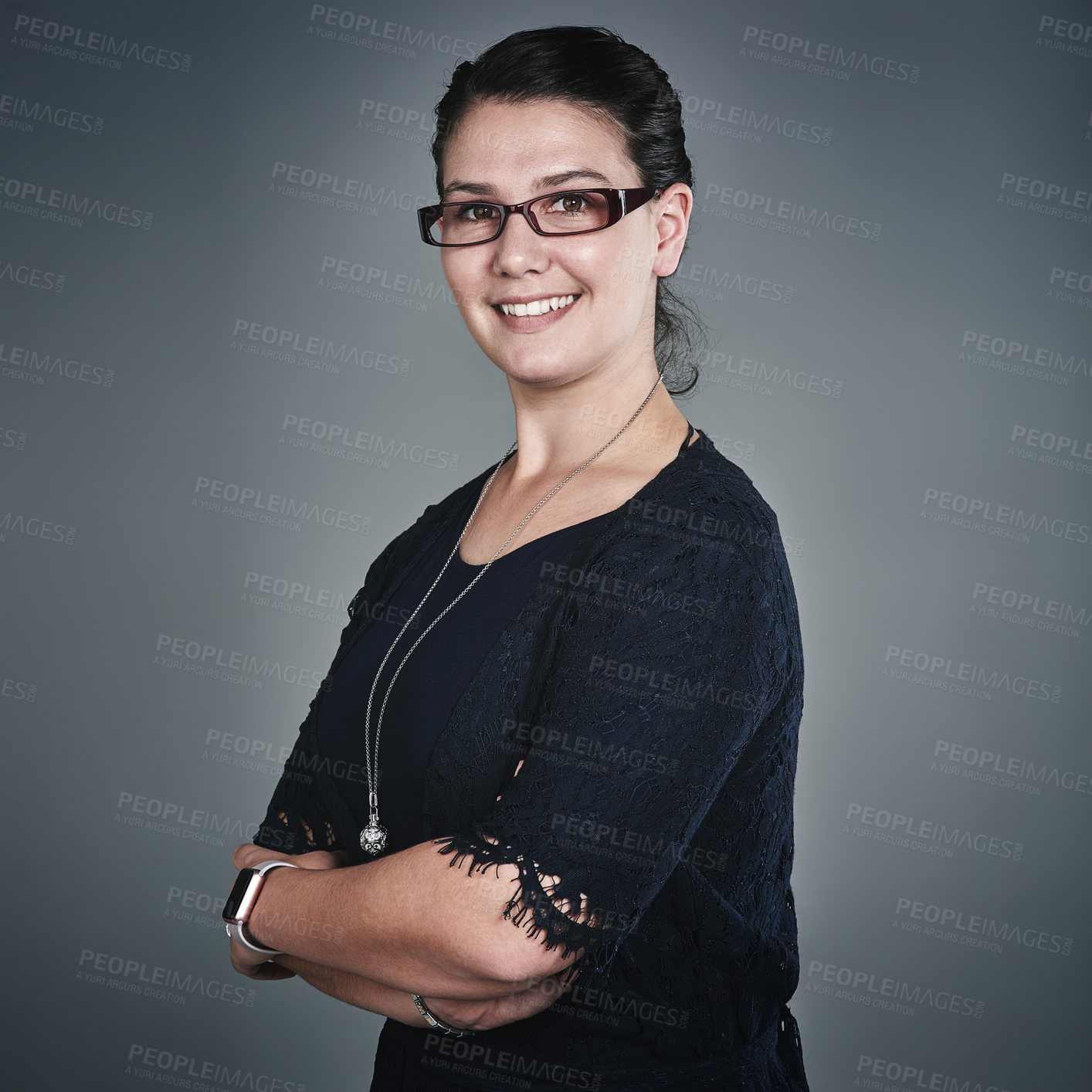 Buy stock photo Studio portrait of a confident young businesswoman posing against a grey background