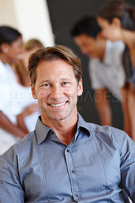 Buy stock photo Portrait, man and smile with creative team in office, entrepreneur with businesspeople in meeting for collaboration. Startup, partnership with happy male person, new job opportunity with confidence