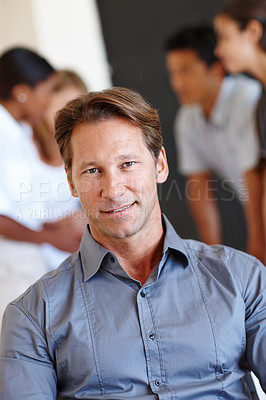 Buy stock photo Portrait, man and confident with creative team in office, entrepreneur with businesspeople in meeting for collaboration. Startup, partnership with happy male person, new job opportunity for career