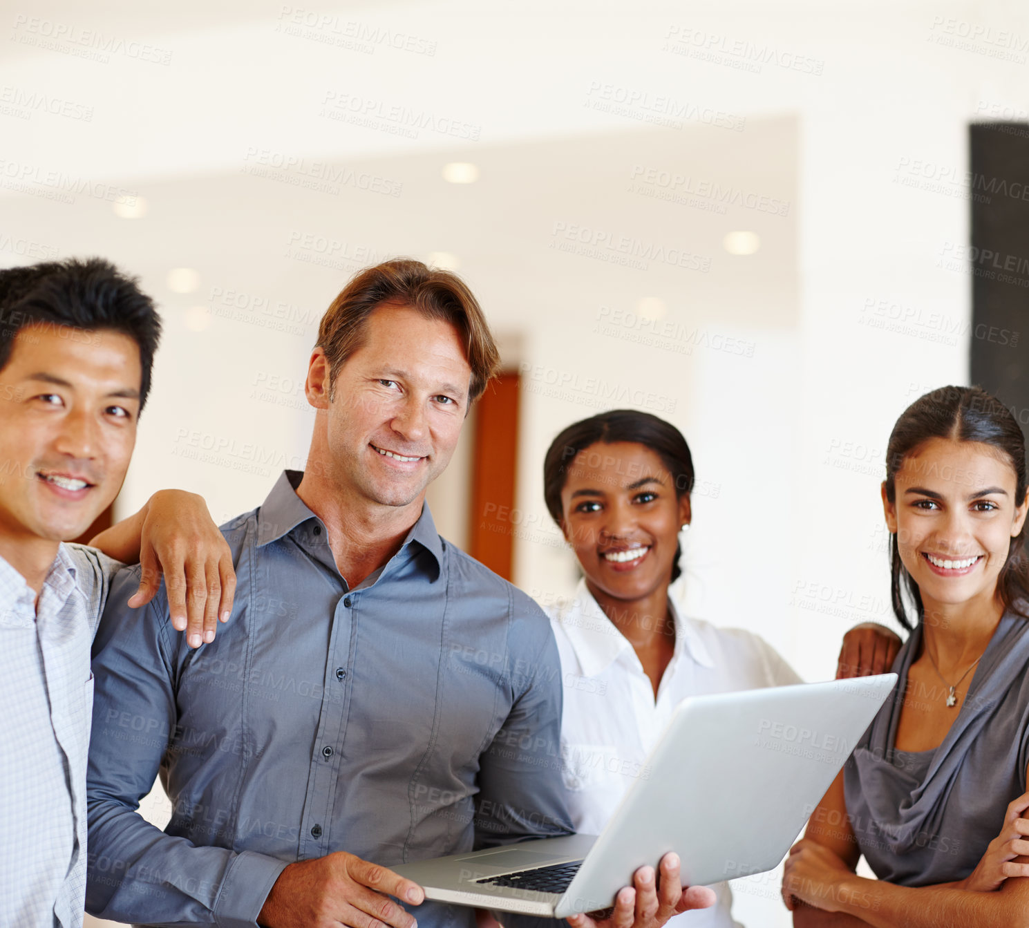 Buy stock photo Portrait of a group of office workers standing around a laptop
