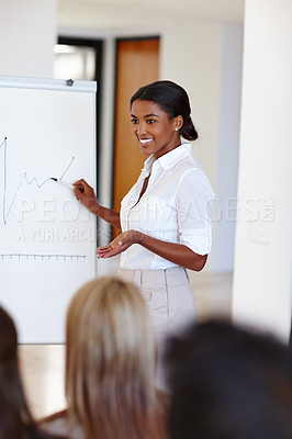 Buy stock photo Shot of a young african woman doing a presentation at a work seminar