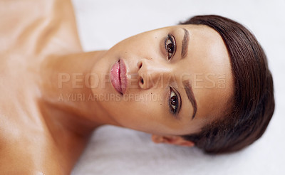 Buy stock photo Top view, portrait and young woman on massage bed for wellness, beauty treatment or body care. Spa, relax and female person at luxury resort for stress relief, comfort or peace on weekend break