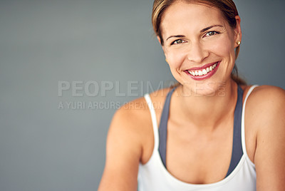 Buy stock photo Portrait of a sporty young woman sitting against a grey background