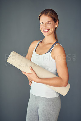 Buy stock photo Happy woman, portrait smile and yoga mat for exercise, healthy wellness or workout against a grey studio background. Excited female person or yogi smiling for mindfulness, zen fitness or body health