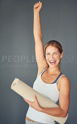 Buy stock photo Happy woman, portrait and yoga with fist in celebration for healthy exercise against a grey studio background. Excited female person or yogi with smile for winning, fitness or workout success at gym