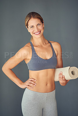 Buy stock photo Happy woman, fitness and portrait smile for yoga exercise, zen workout or healthy body against a grey studio background. Female person or yogi smiling with mat for spiritual wellness or mental health