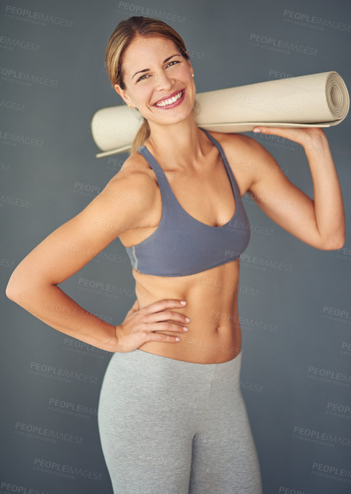 Buy stock photo Happy woman, portrait and yoga mat for zen workout, exercise or healthy body against a grey studio background. Female person or yogi with smile for spiritual wellness, fitness and mental health