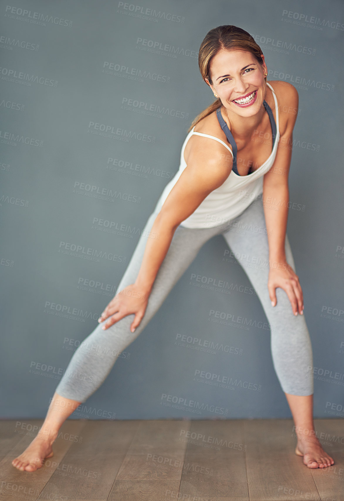 Buy stock photo Fitness, woman and smile with stretch in portrait for yoga, aerobics class and muscle flexibility in studio. Smile, female person or athlete with warm up exercise for balance and cardio preparation