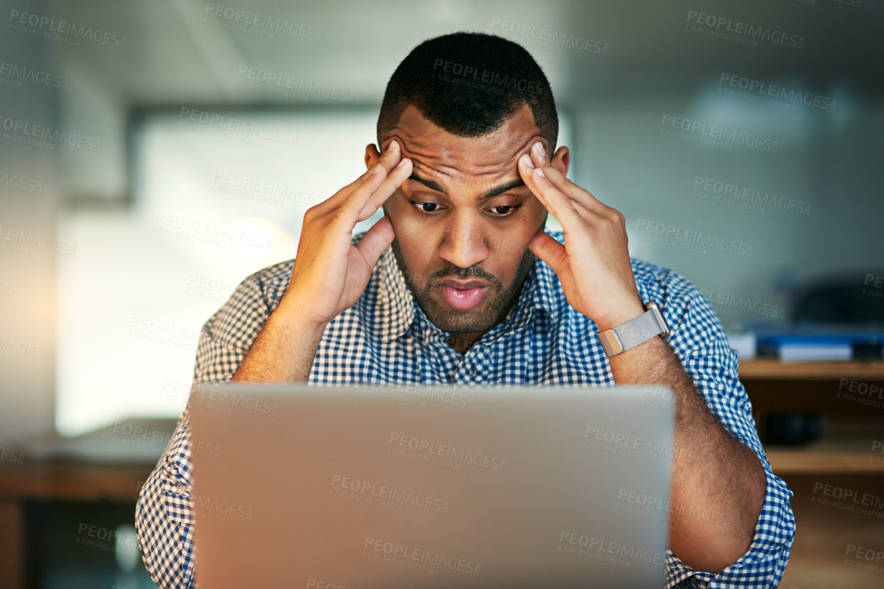 Buy stock photo Cropped shot of a young businessman looking stressed while working in the office