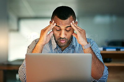 Buy stock photo Cropped shot of a young businessman looking stressed while working in the office