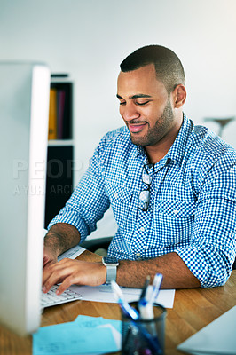 Buy stock photo Cropped shot of a handsome young businessman working in his office