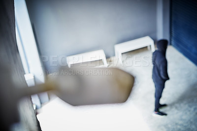 Buy stock photo High angle shot of a sketchy-looking man standing outside a building