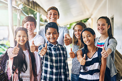 Buy stock photo Portrait of a group of happy schoolchildren showing a thumbs up outside their classroom