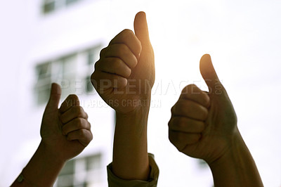 Buy stock photo Cropped shot of three coworkers' hands giving the thumbs up