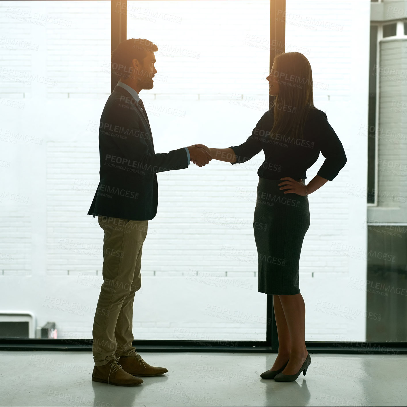 Buy stock photo Full length shot of two corporate businesspeople shaking hands in the lobby