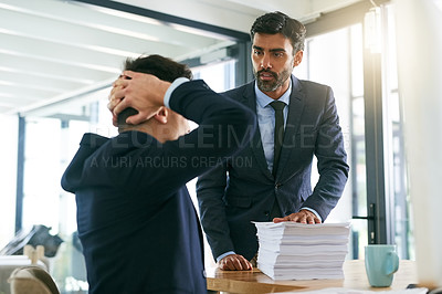 Buy stock photo Shot of a businessman reprimanding one his employees in the office