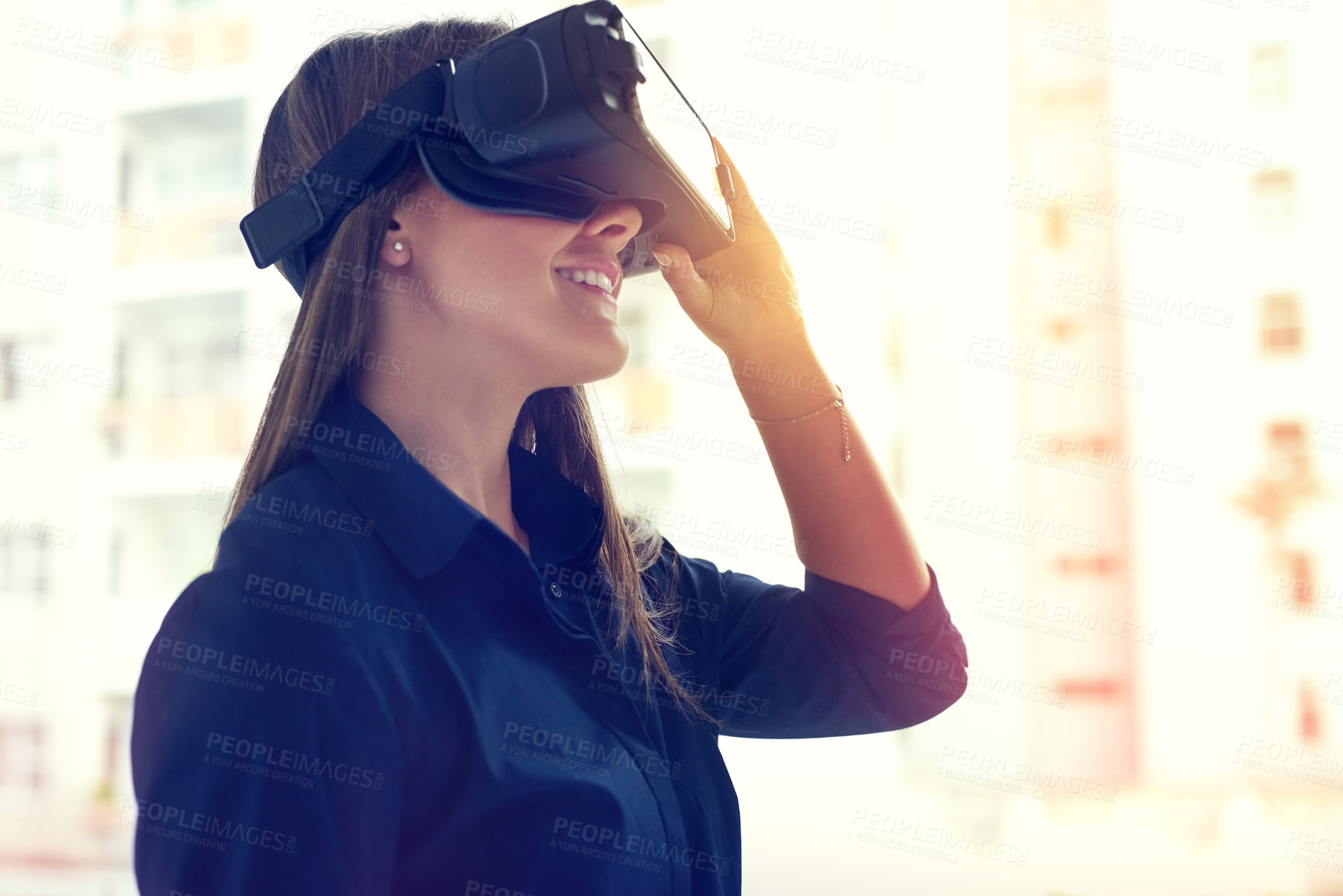 Buy stock photo Shot of a young businesswoman wearing a VR headset in an office