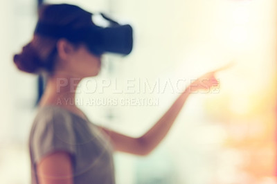 Buy stock photo Defocused shot of a young businesswoman wearing a VR headset while connecting to a user interface in an office