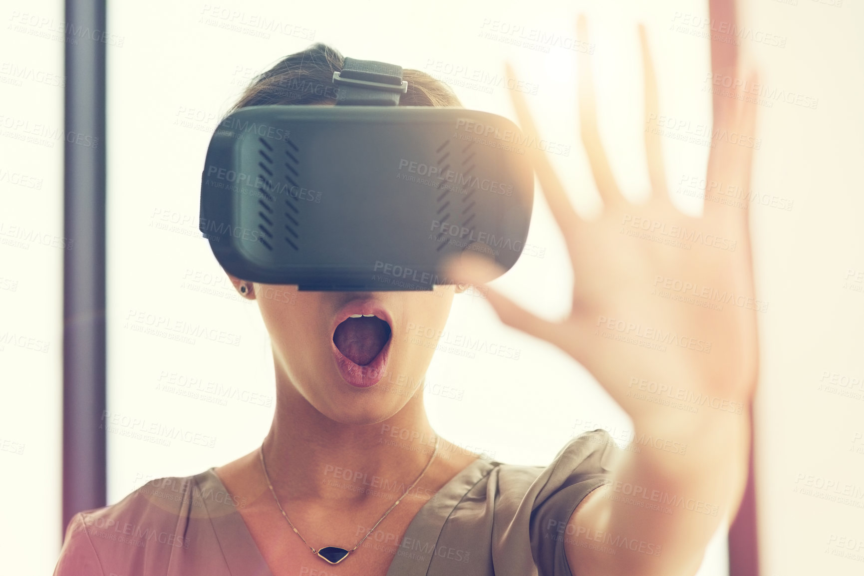 Buy stock photo Shot of a young businesswoman wearing a VR headset while connecting to a user interface in an office