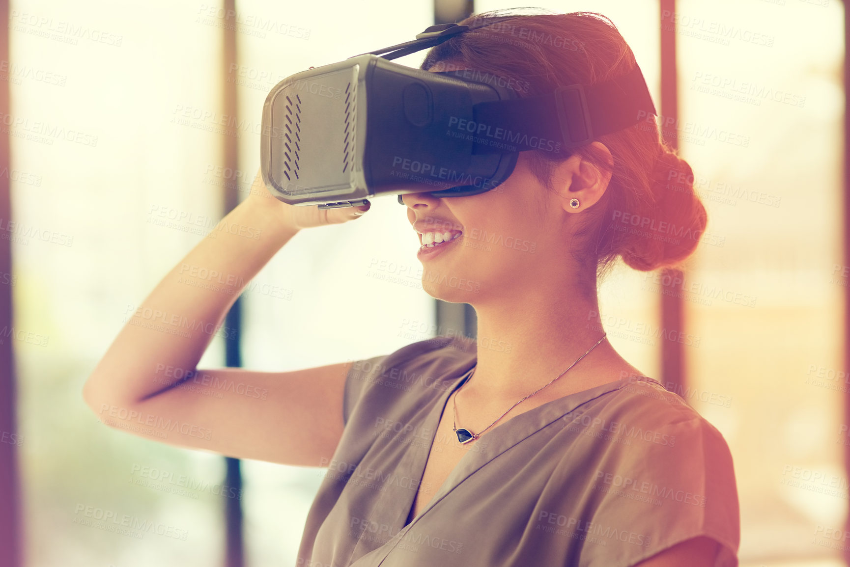 Buy stock photo Shot of a young businesswoman wearing a VR headset in an office