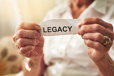 Buy stock photo Cropped shot of an elderly woman holding a piece of paper with the word “legacy” on it