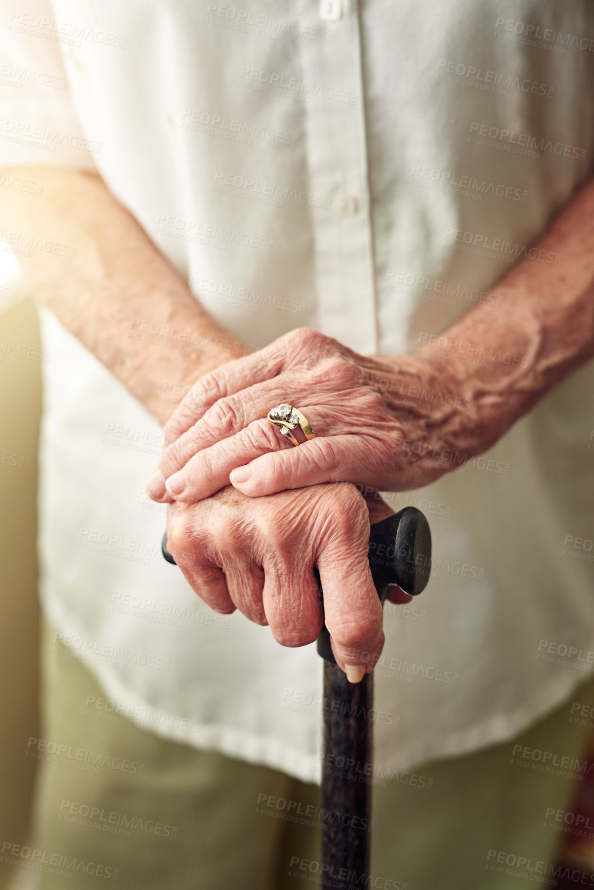 Buy stock photo Hands, cane and closeup of senior woman with disabled injury with balance in retirement in house. Walking stick, elderly lady and person with disability, support or recovery in home with lens flare