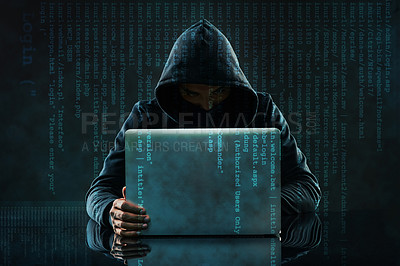 Buy stock photo Shot of an unidentifiable computer hacker using a laptop against a dark background in studio