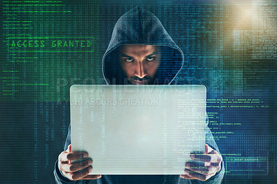 Buy stock photo Portrait of a serious computer hacker using a laptop against a dark background in studio