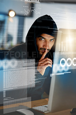 Buy stock photo Portrait of a serious computer hacker hacking into a computer in an office