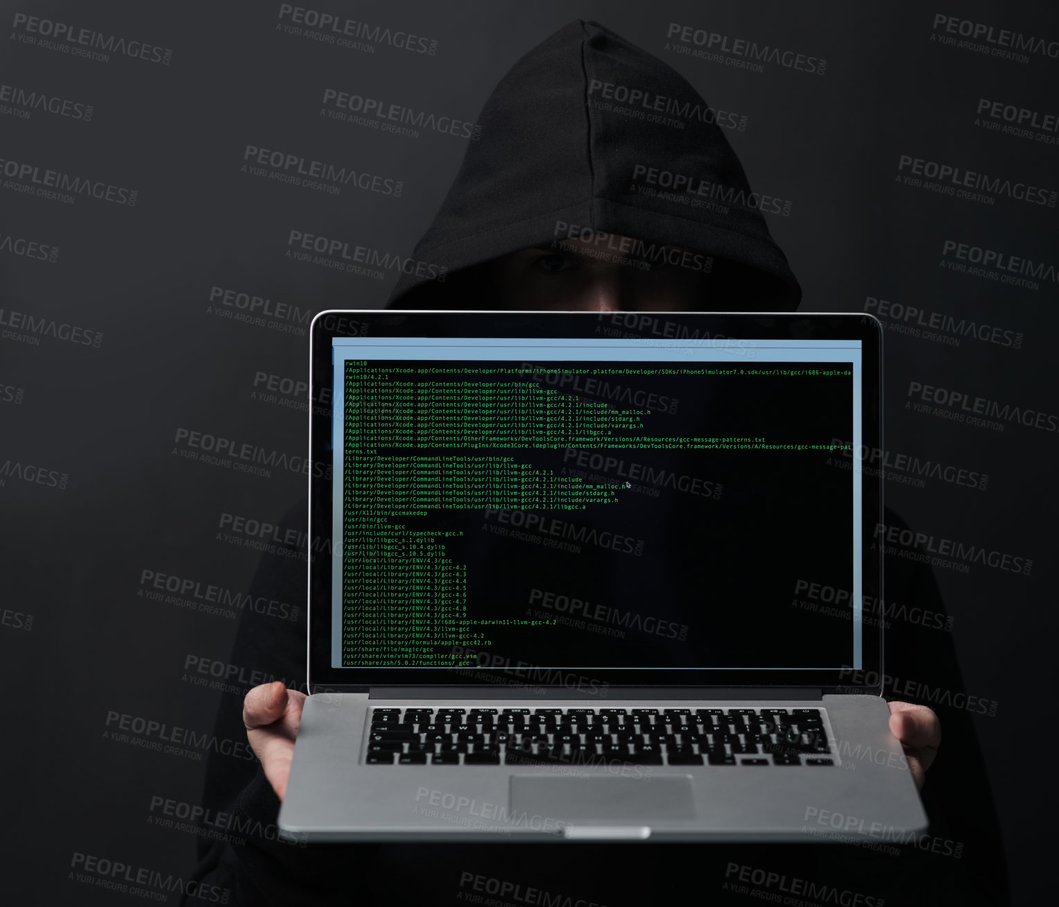 Buy stock photo Shot of an unidentifiable computer hacker holding up a laptop against a dark background