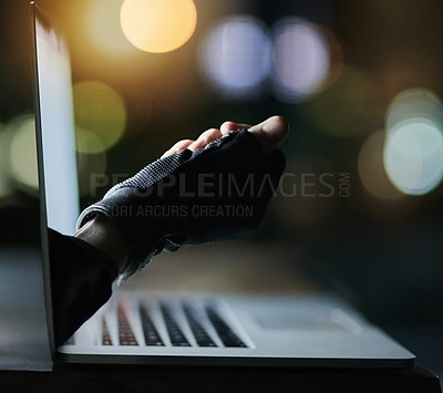Buy stock photo Shot of a hacker's disembodied hand reaching through a laptop screen