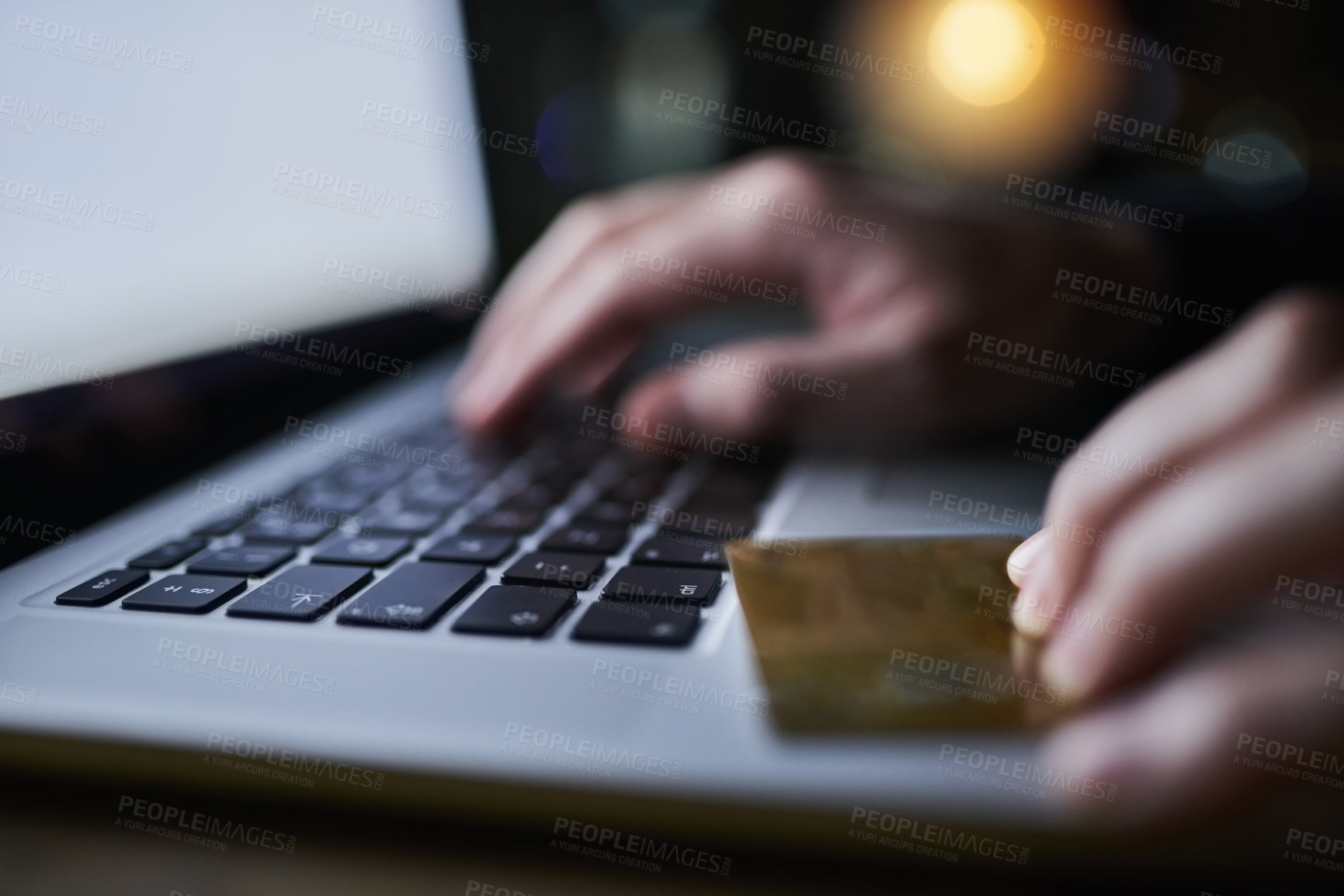 Buy stock photo Shot of an unidentifiable criminal using a laptop to hack into a credit account