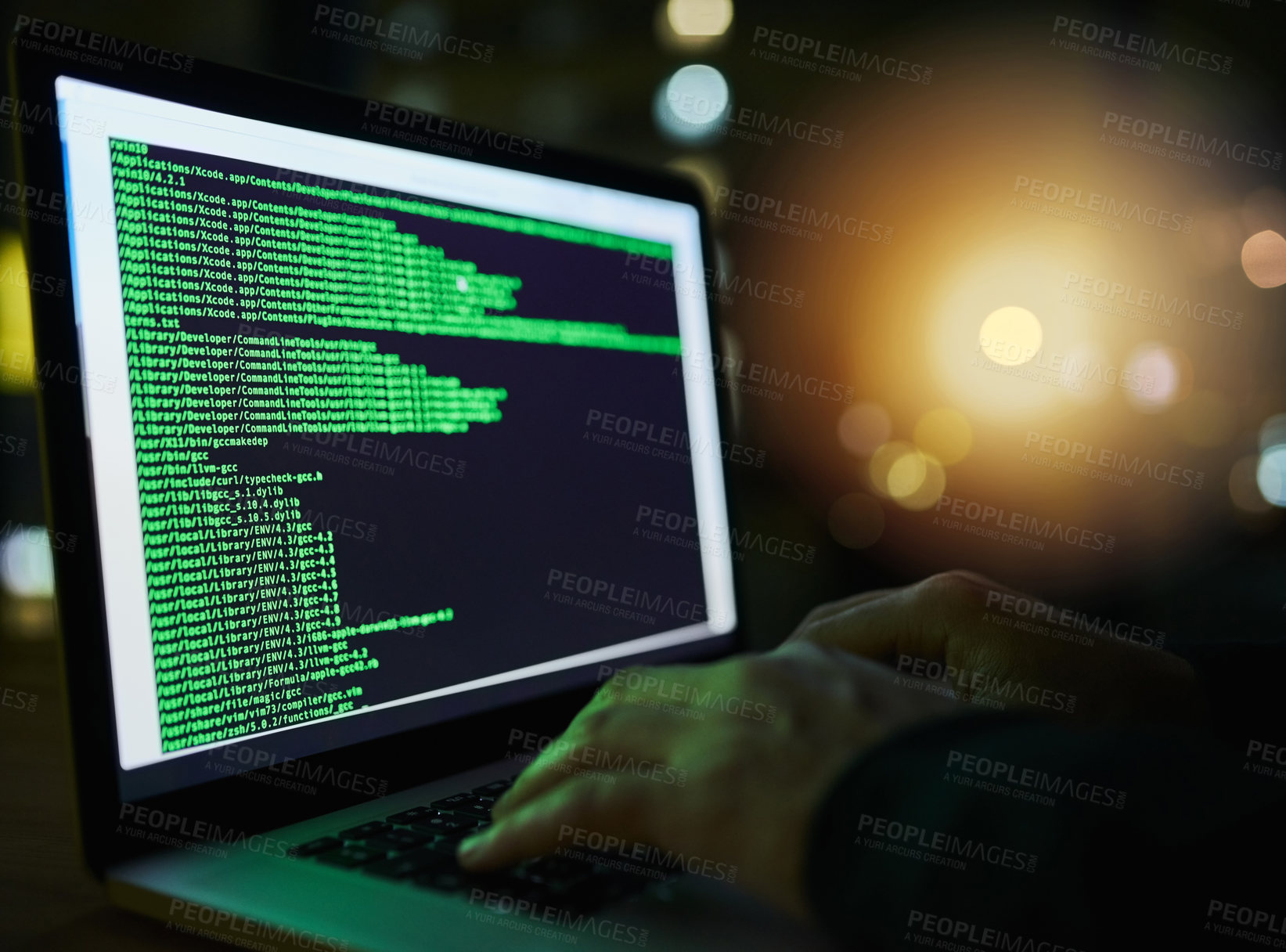 Buy stock photo Shot of an unrecognizable computer hacker using a laptop late at night